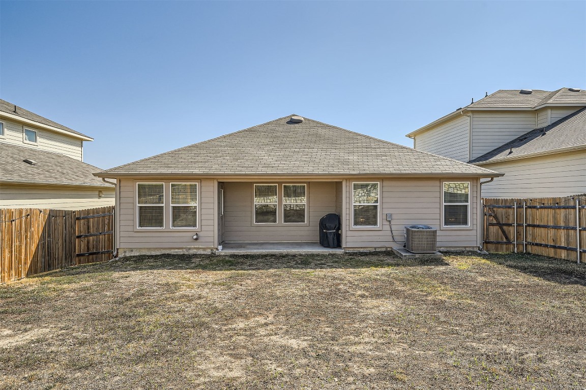 6404 Diamondleaf Bend Austin, TX 78724 - Photo 26 of 29 Rear view of house with a patio, a shingled roof, and a fenced backyard