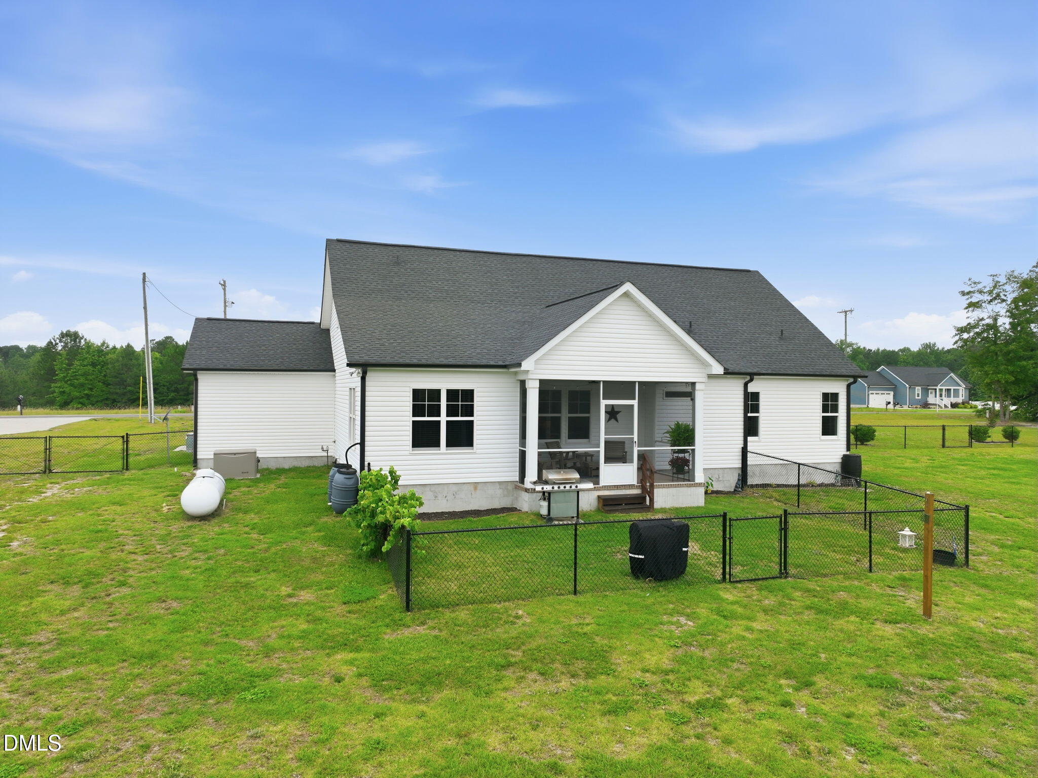 5098 Spring Hill Church Road Lillington, NC 27546 - Photo 34 of 36 a view of a house with a backyard porch and sitting area