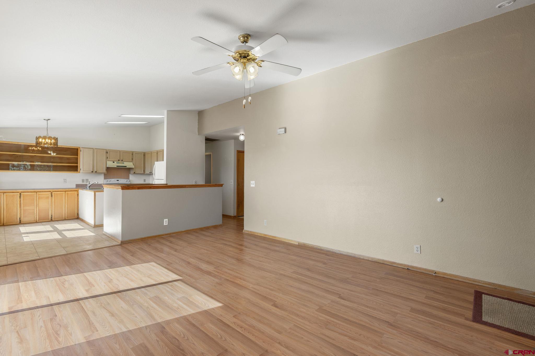 720 Sawmill Road Durango, CO 81303 - Photo 5 of 41 a view of a kitchen with wooden floor and an empty space