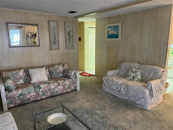 a living room with furniture and a lamp