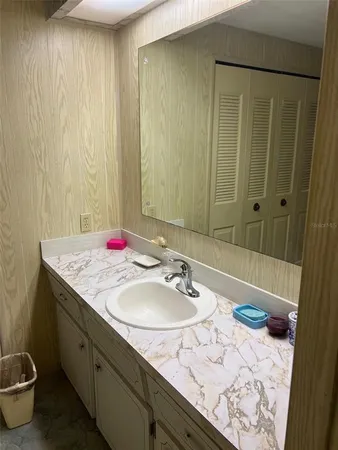 a bedroom with a bed wooden floor and potted plant