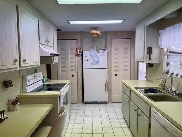 a kitchen with stainless steel appliances a refrigerator sink and cabinets