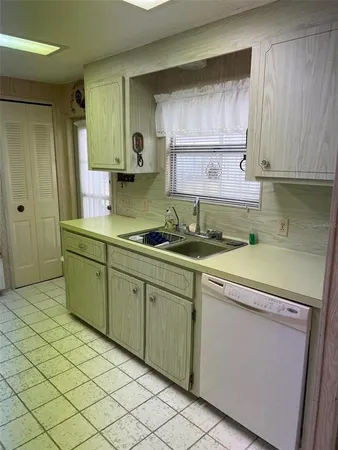 a kitchen with sink cabinets and window