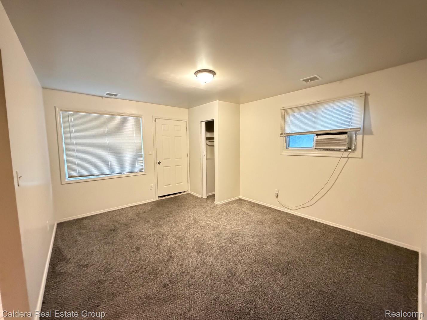 15354 Lahser Road Detroit, MI 48223 - Photo 3 of 10 Unfurnished bedroom with carpet flooring and a closet