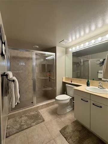 a bathroom with a toilet sink and shower