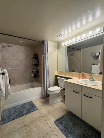 a bathroom with a double vanity sink toilet and shower