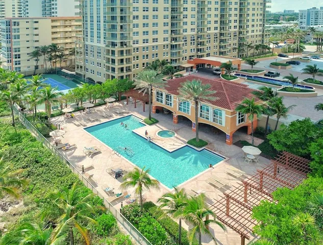 a aerial view of multiple houses with yard