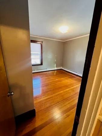 a view of a room with wooden floor and entrance