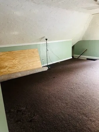 a view of a room with an empty space and a window