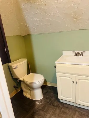 a white toilet sitting next to a bathroom sink