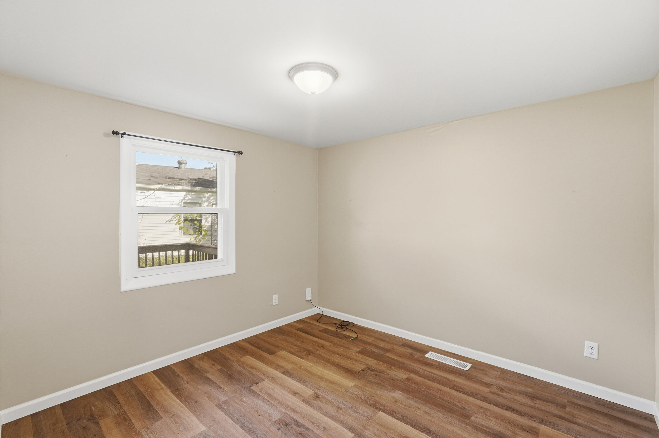 319 Michigami Trail Chesterton, IN 46304 - Photo 12 of 19 a view of an empty room with wooden floor and a window