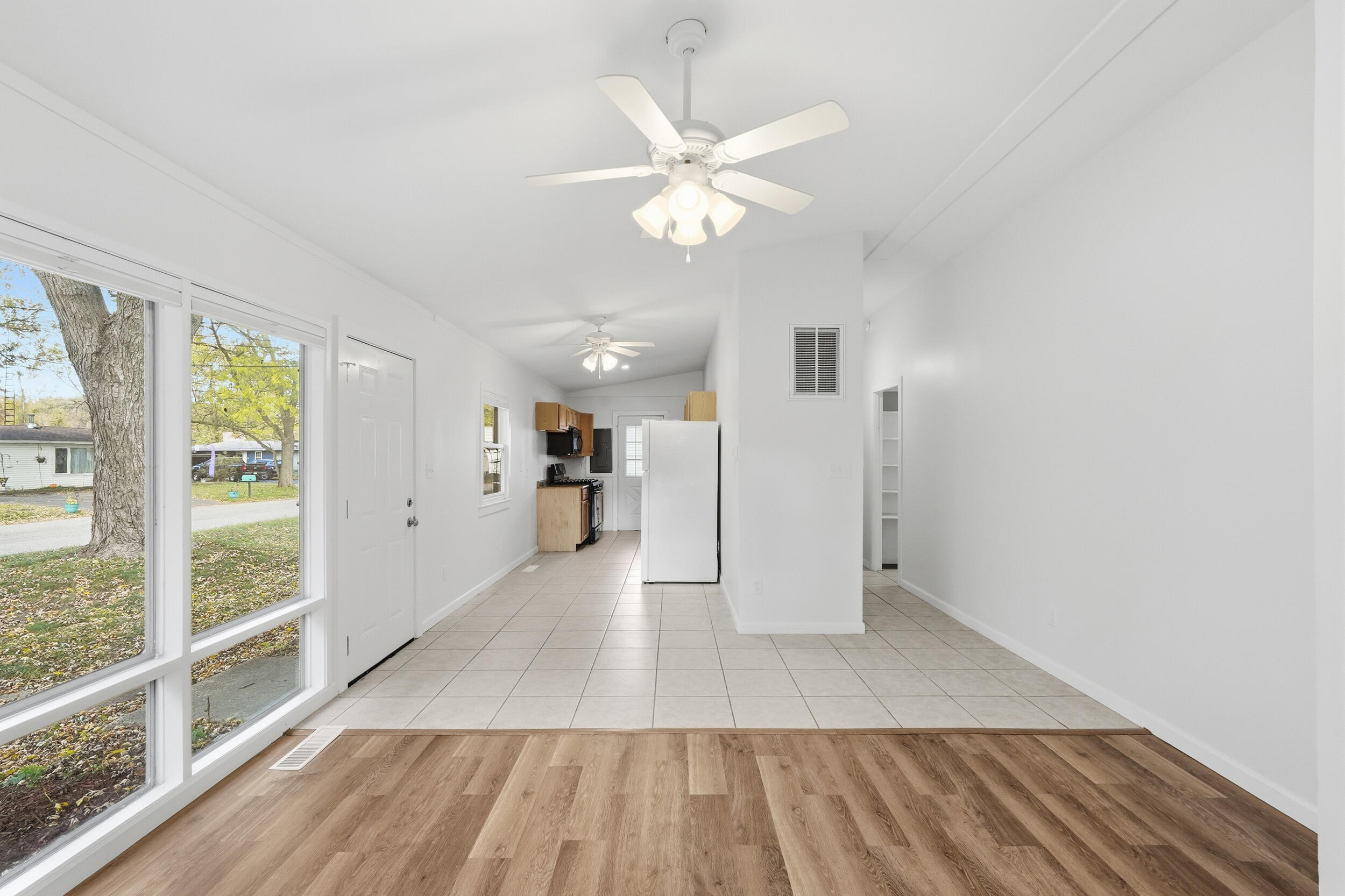 319 Michigami Trail Chesterton, IN 46304 - Photo 4 of 19 a view of a kitchen with wooden floor and a ceiling fan