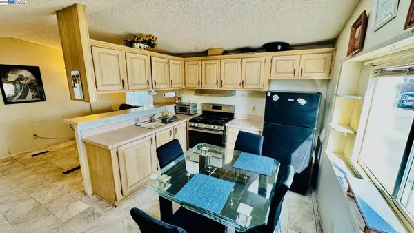 a kitchen with a table chairs and a refrigerator