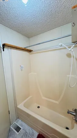 a bathroom with a shower and a sink