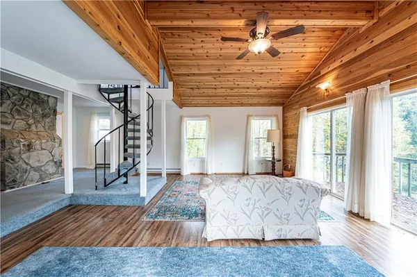 a living room with couch and wooden floor