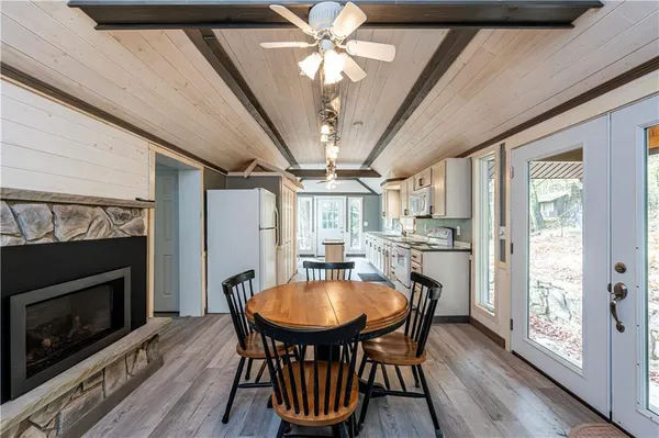 a dining room with furniture a fireplace and wooden floor