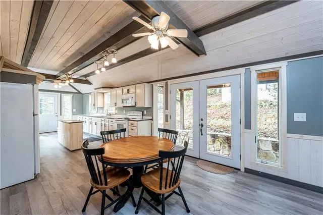 a view of a dining room with furniture window and wooden floor