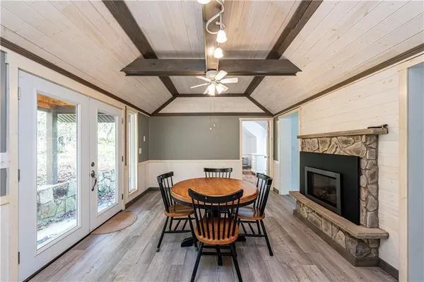 a dining room with furniture a fireplace and wooden floor