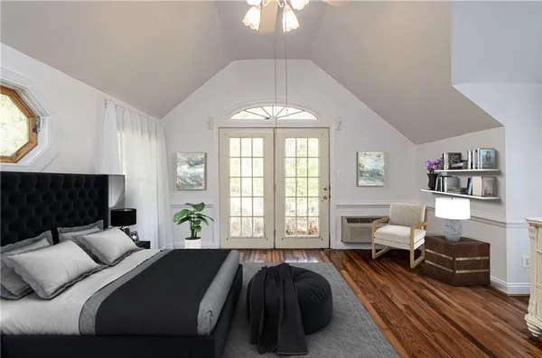 a spacious bedroom with a bed and a large window