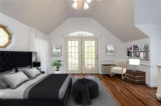a spacious bedroom with a bed and a large window