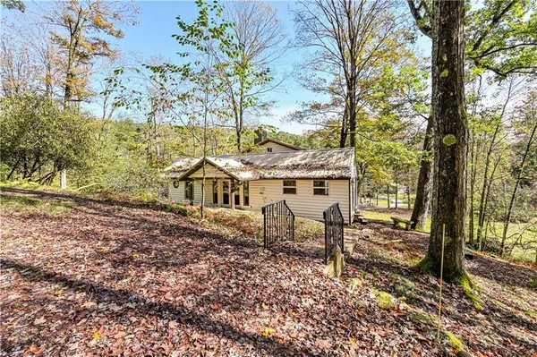 a view of a house with a yard and sitting area