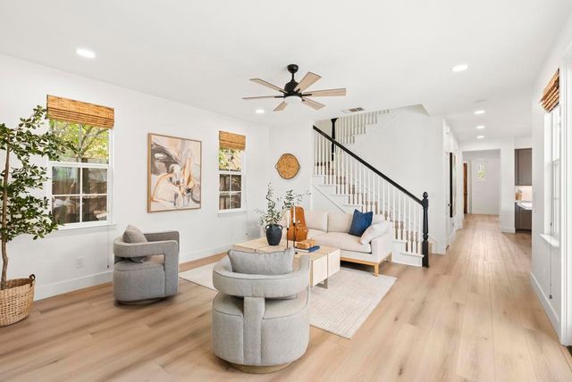 a living room with furniture and wooden floor