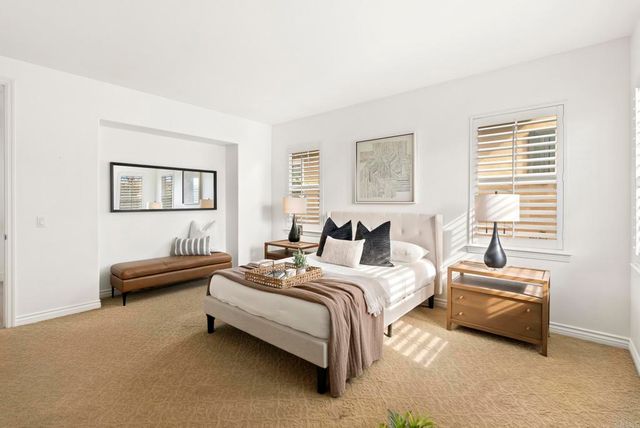 a bedroom with bed and a couch