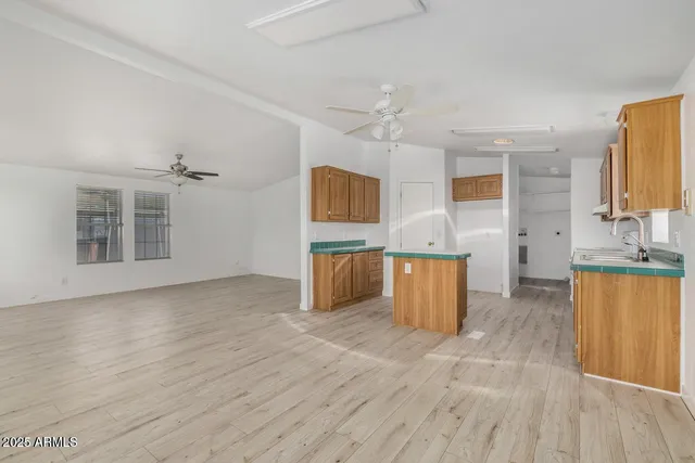 a view of a kitchen with wooden floor and a sink