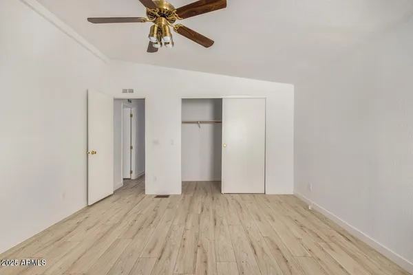 a view of a room with wooden floor and white walls