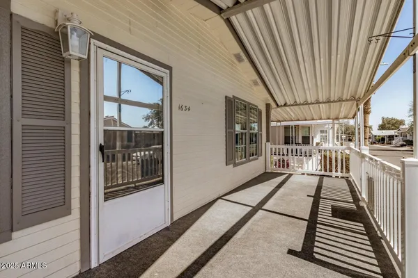 a view of a balcony with wooden floor