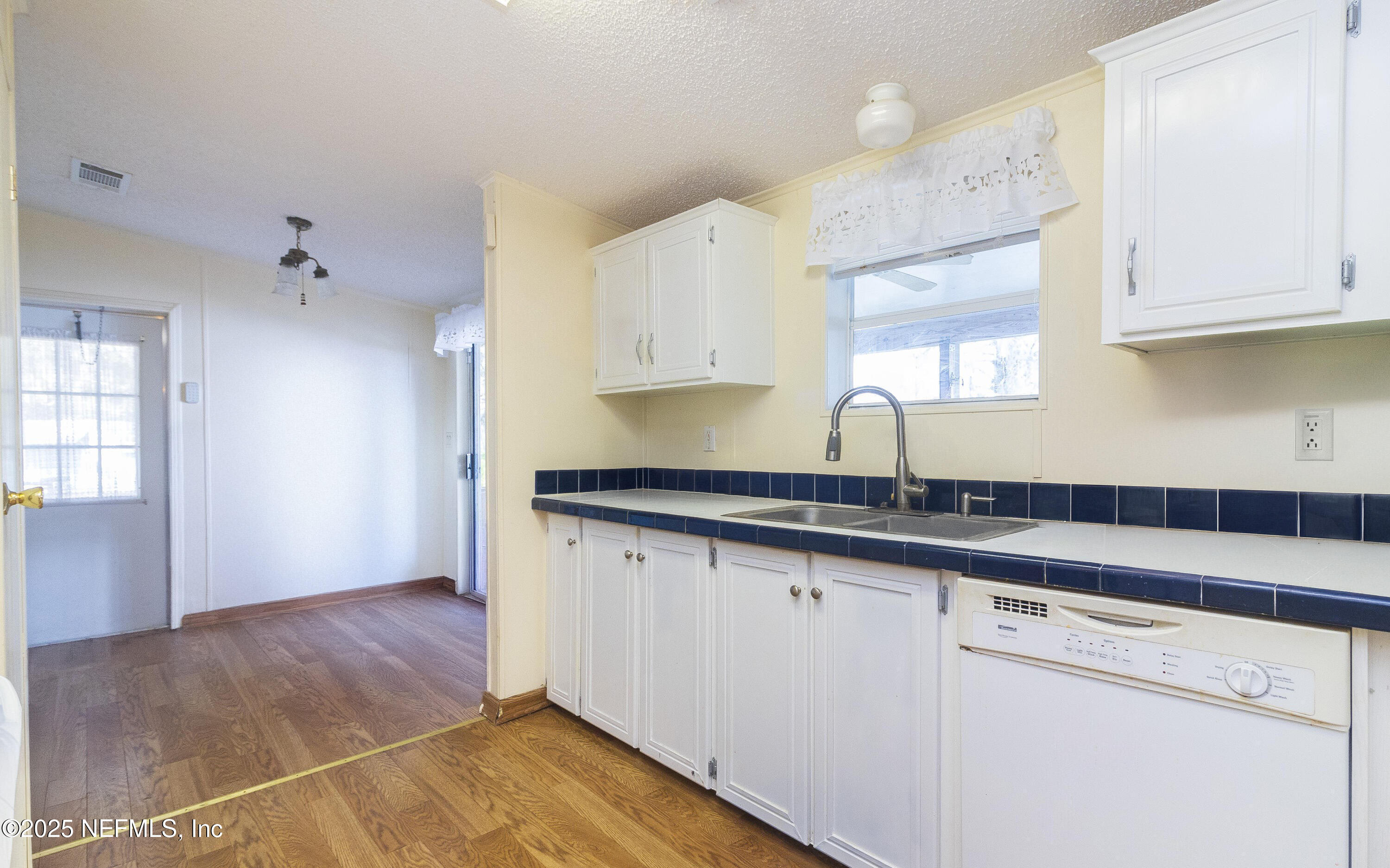 222 Kitty Avenue Interlachen, FL 32148 - Photo 19 of 34 a kitchen with granite countertop a sink and cabinets