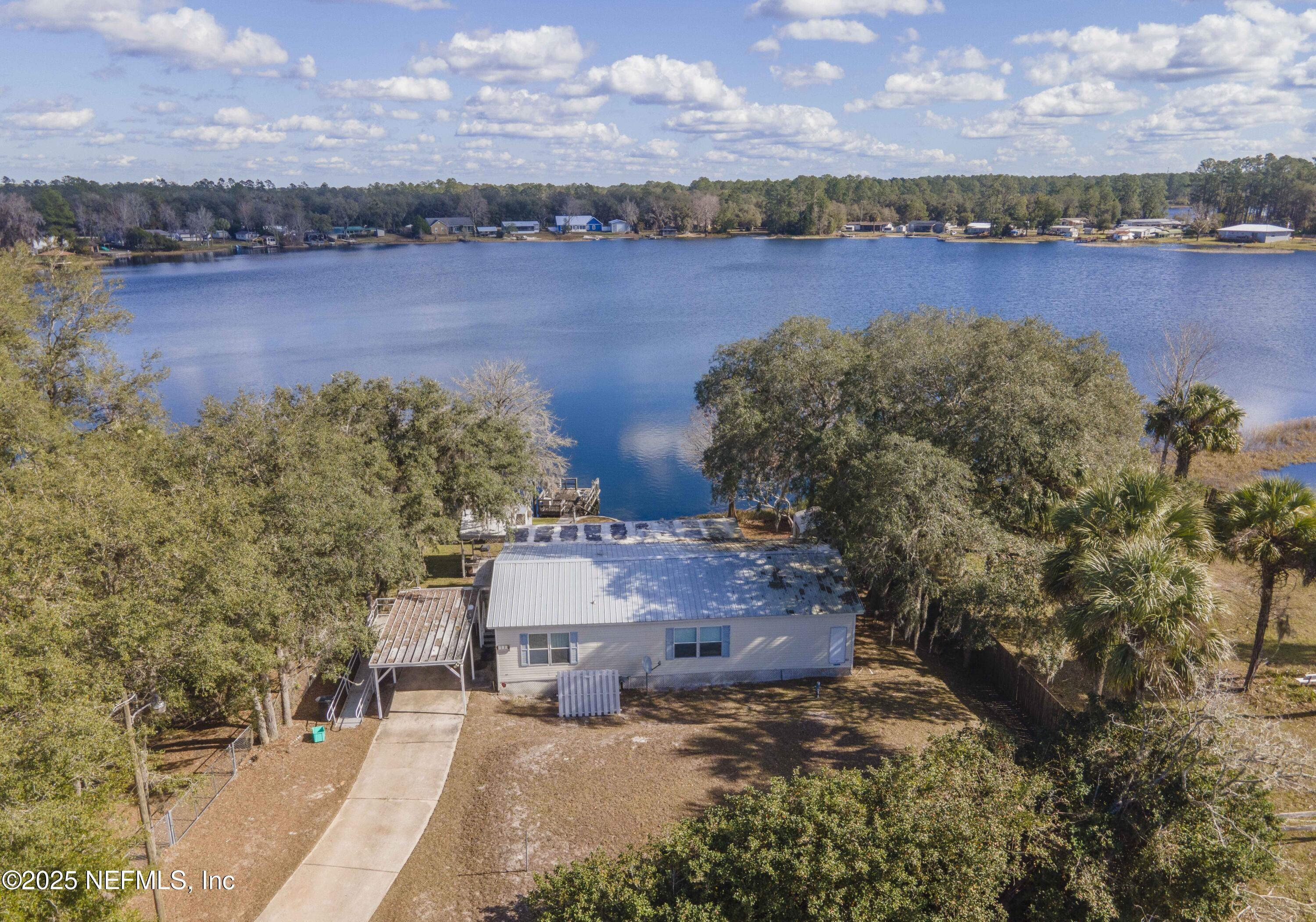 222 Kitty Avenue Interlachen, FL 32148 - Photo 2 of 34 an aerial view of a house with a lake view and mountain view