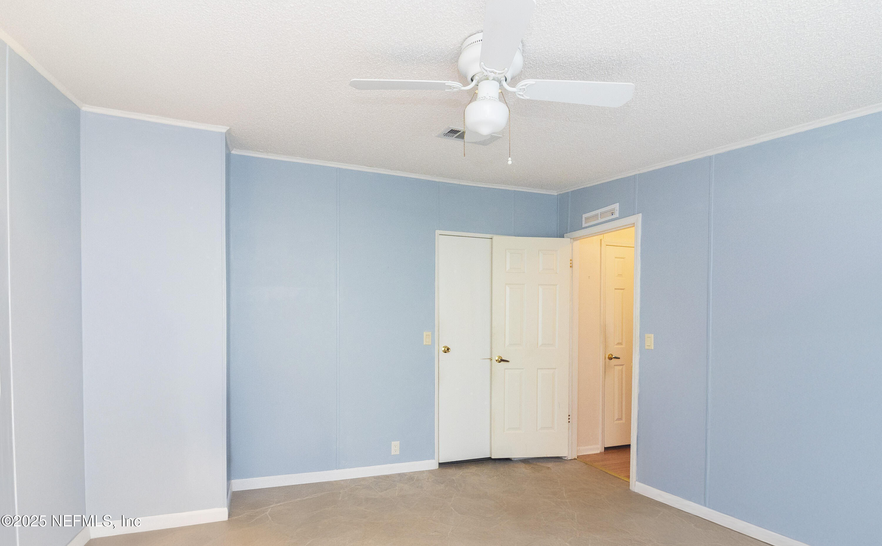 222 Kitty Avenue Interlachen, FL 32148 - Photo 24 of 34 an empty room with a ceiling fan and a window
