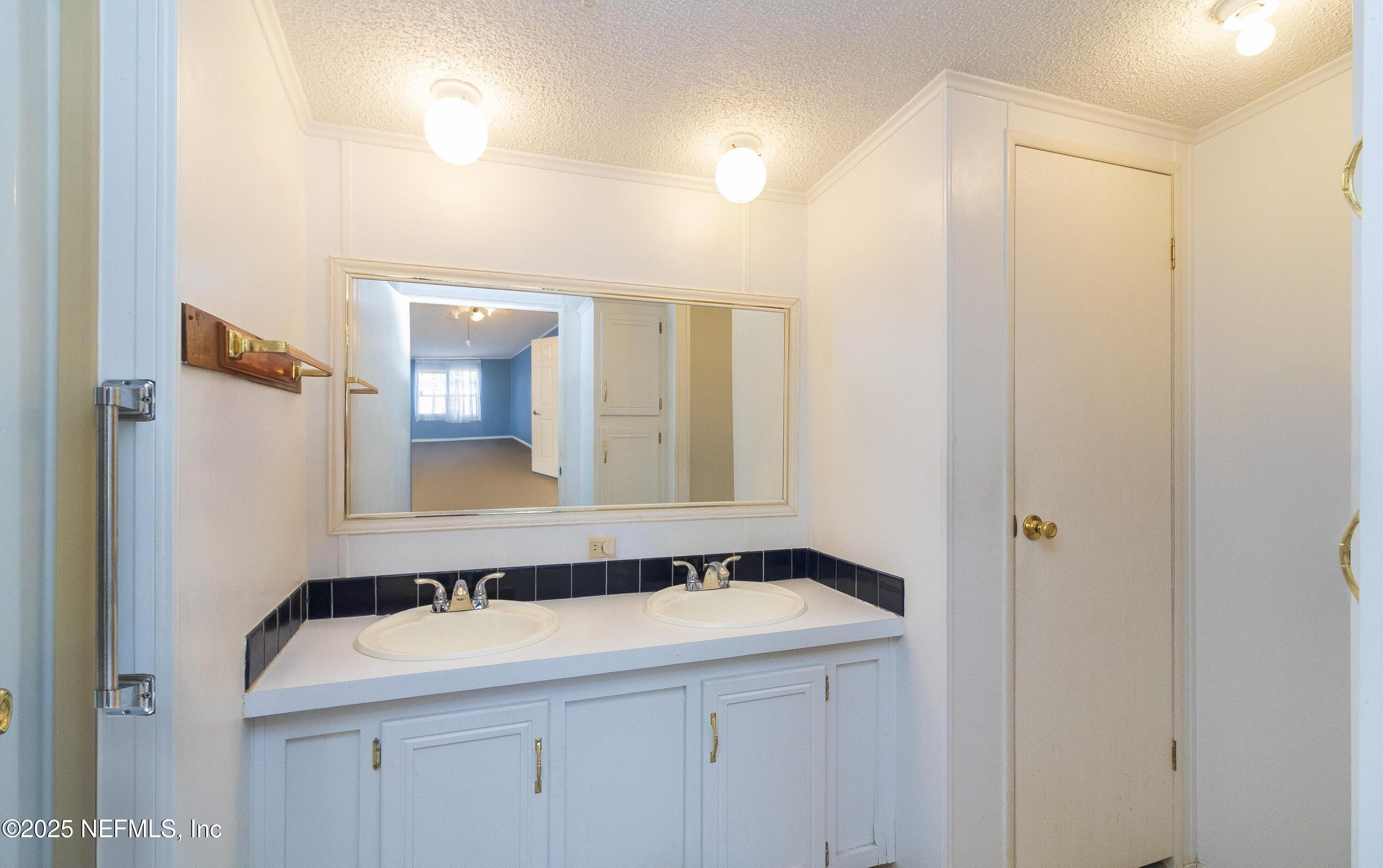 222 Kitty Avenue Interlachen, FL 32148 - Photo 26 of 34 a bathroom with a sink and a mirror