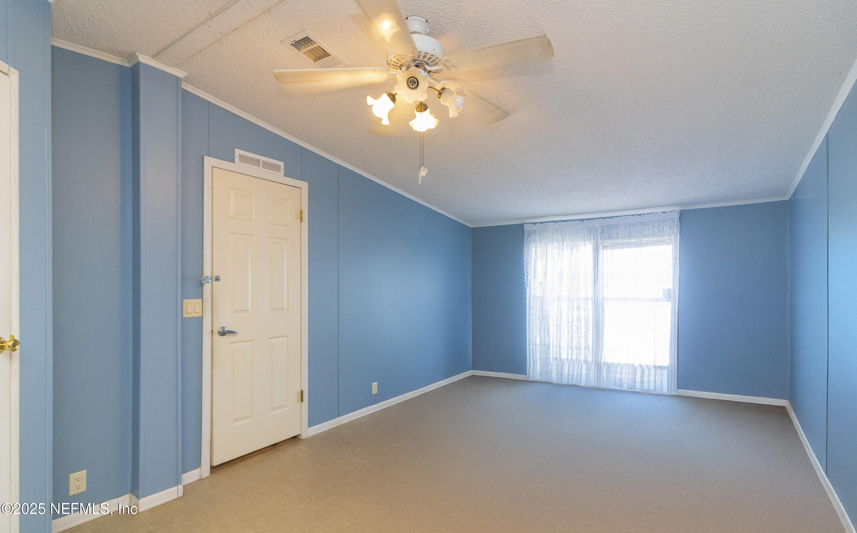 222 Kitty Avenue Interlachen, FL 32148 - Photo 28 of 34 an empty room with windows and chandelier fan