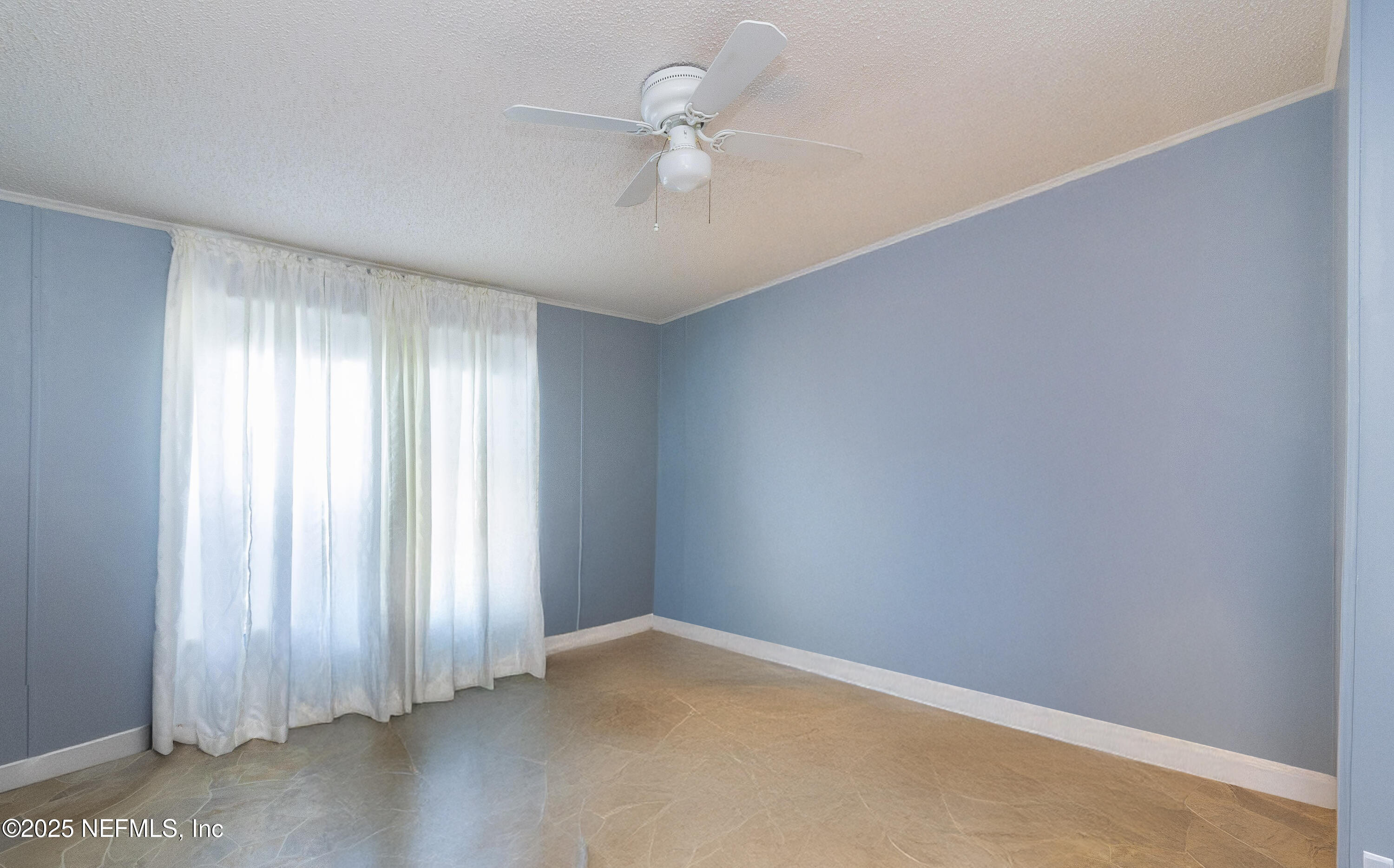 222 Kitty Avenue Interlachen, FL 32148 - Photo 32 of 34 an empty room with windows and fan