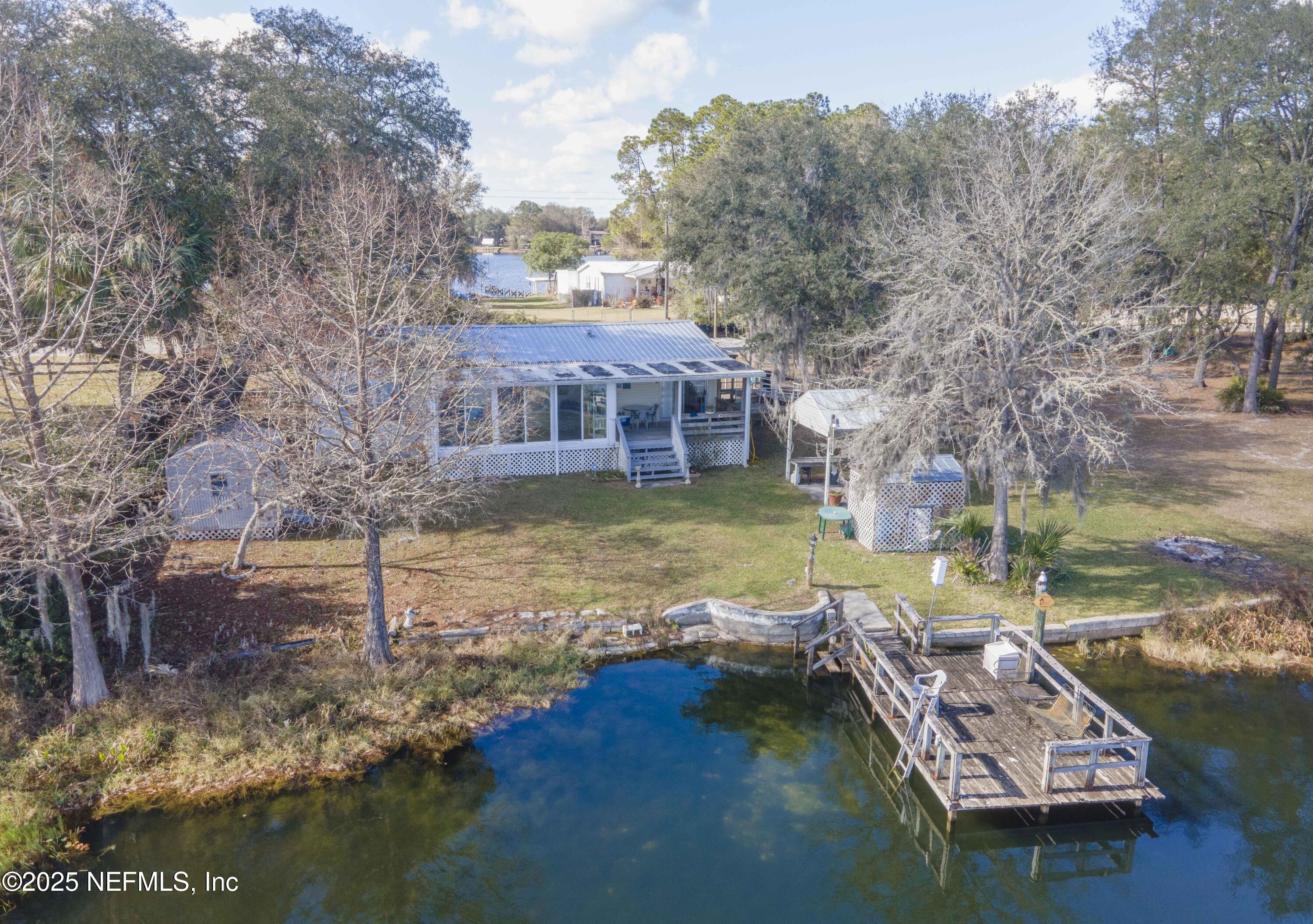 222 Kitty Avenue Interlachen, FL 32148 - Photo 4 of 34 a view of a house with pool and a yard with lake view