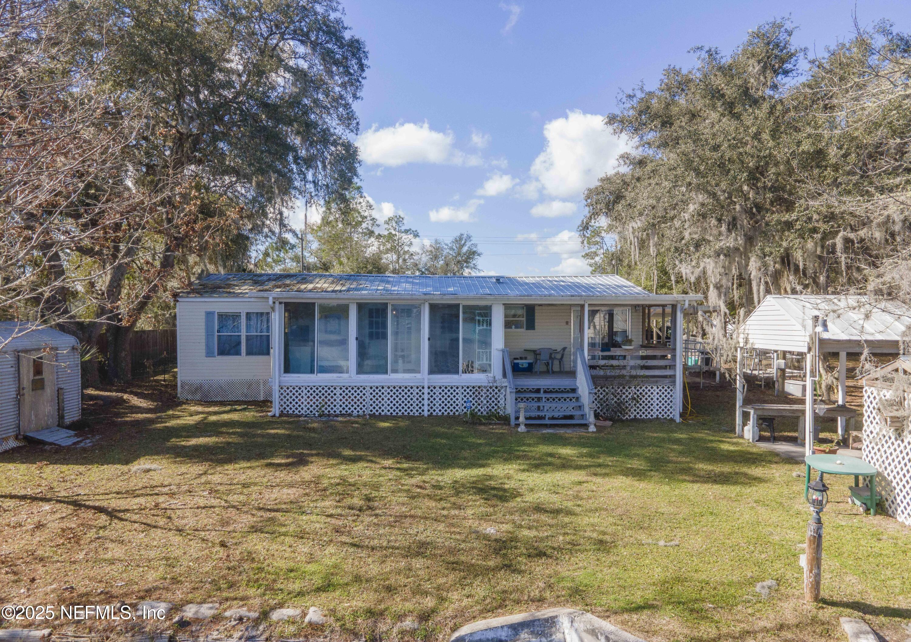 222 Kitty Avenue Interlachen, FL 32148 - Photo 8 of 34 a view of a house with a yard balcony and swimming pool