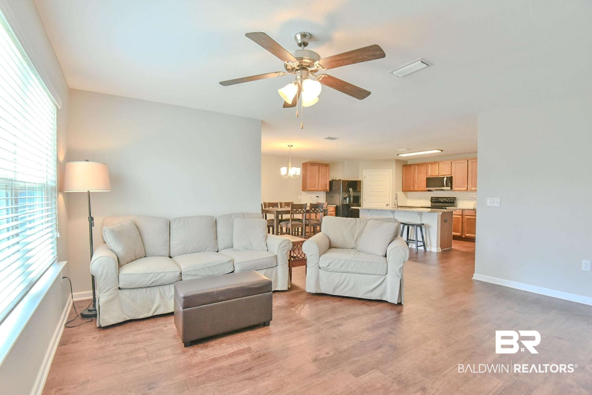 17430 Harding Drive Foley, AL 36535 - Photo 11 of 37 Living room featuring a healthy amount of sunlight, light wood-style flooring, visible vents, and ceiling fan with notable chandelier