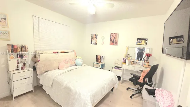 a bedroom with furniture and a flat screen tv