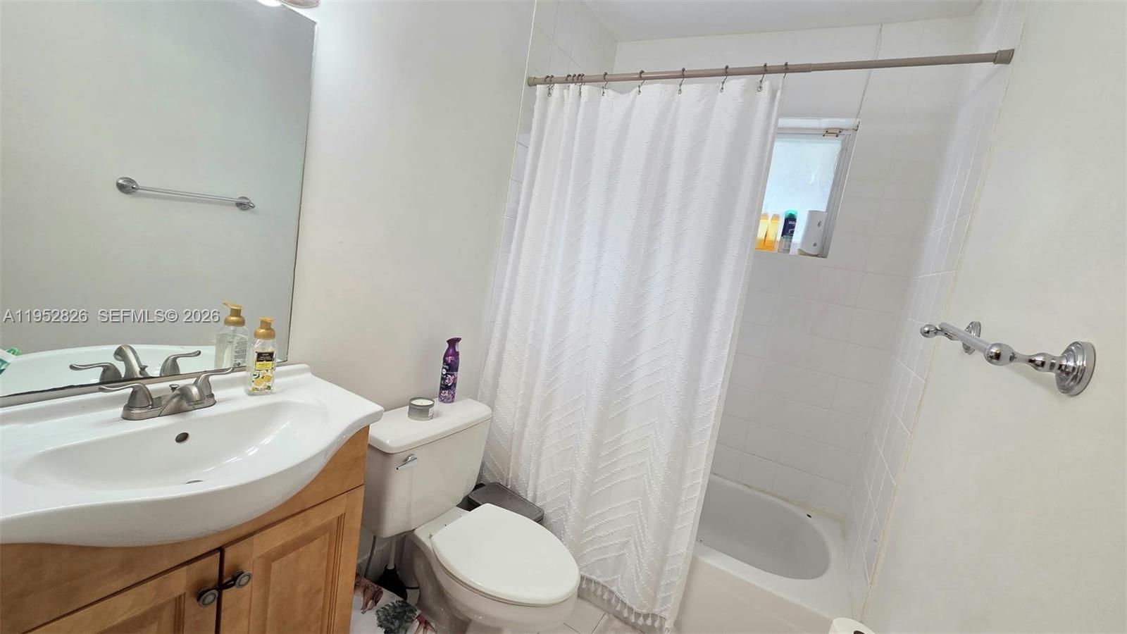 7911 Southwest 152nd Avenue, Unit 1008 Miami, FL 33193 - Photo 14 of 17 a bathroom with a sink a toilet and shower