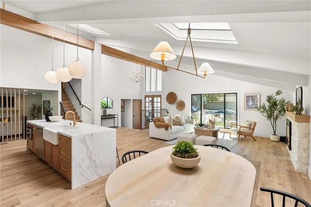 a living room with furniture kitchen and a large window
