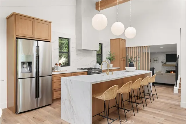 a kitchen with stainless steel appliances granite countertop a sink and a refrigerator