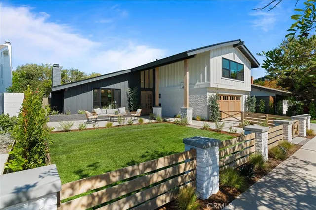 a front view of house with a garden and patio