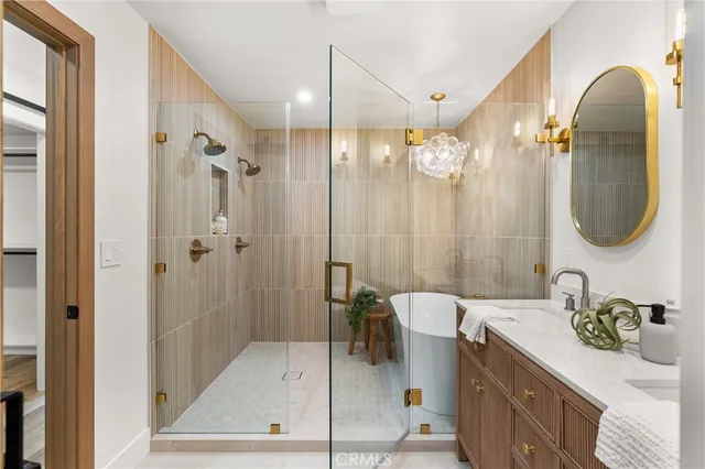 a bathroom with a double vanity sink a mirror a bathtub and shower