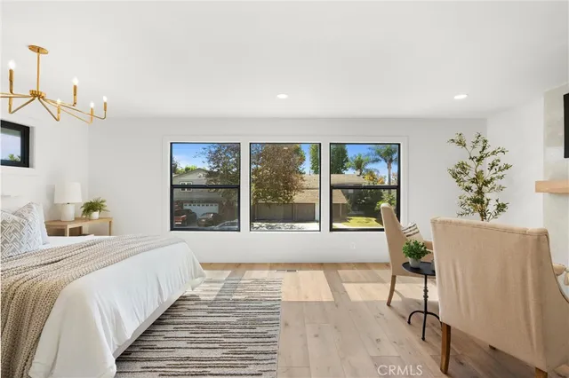 a bedroom with a large bed and a large window