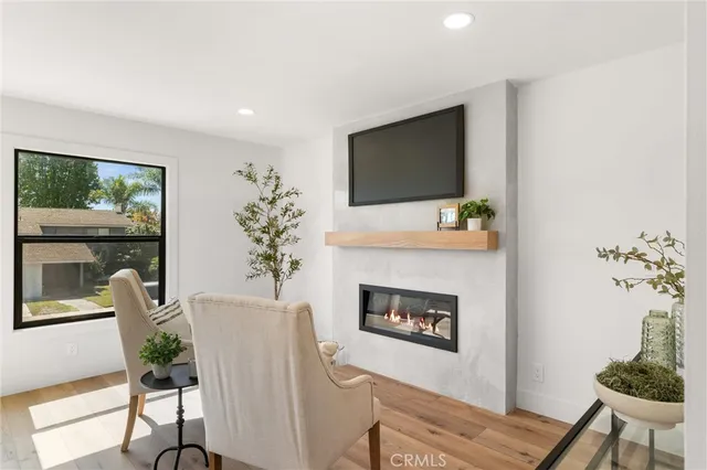 a bedroom with a bed window and a flat tv screen