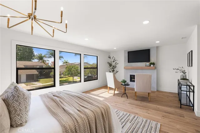 a bedroom with a bed and a painting on the wall