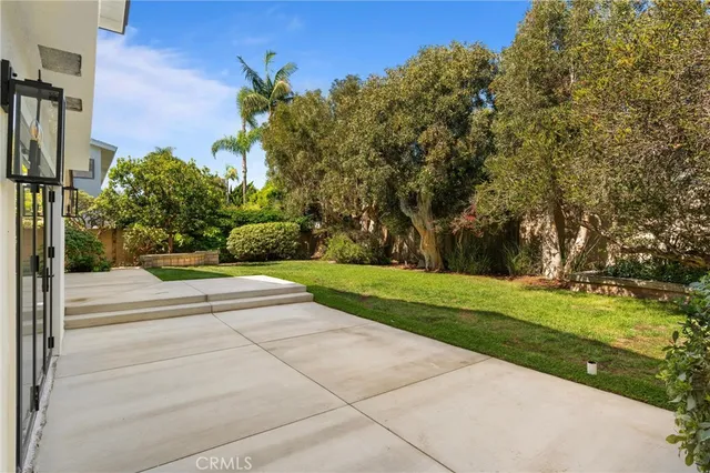 an aerial view of a house with a yard and pool