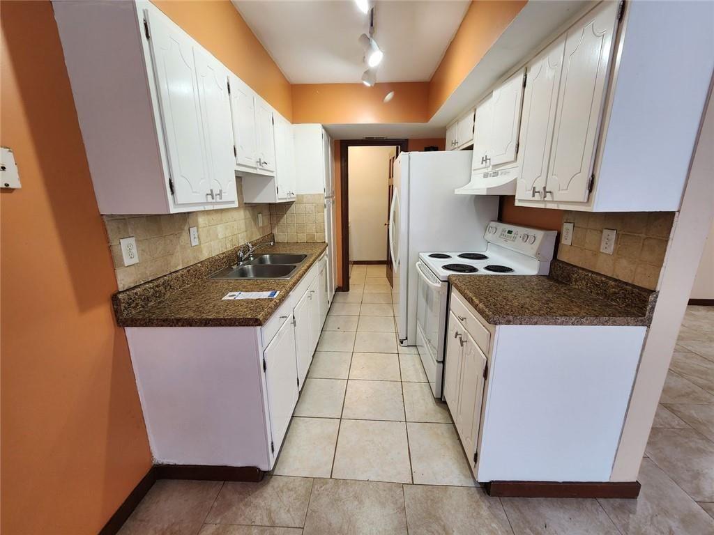 3186 Quince Tree Lane Decatur, GA 30034 - Photo 8 of 24 a kitchen with granite countertop a sink a stove and cabinets